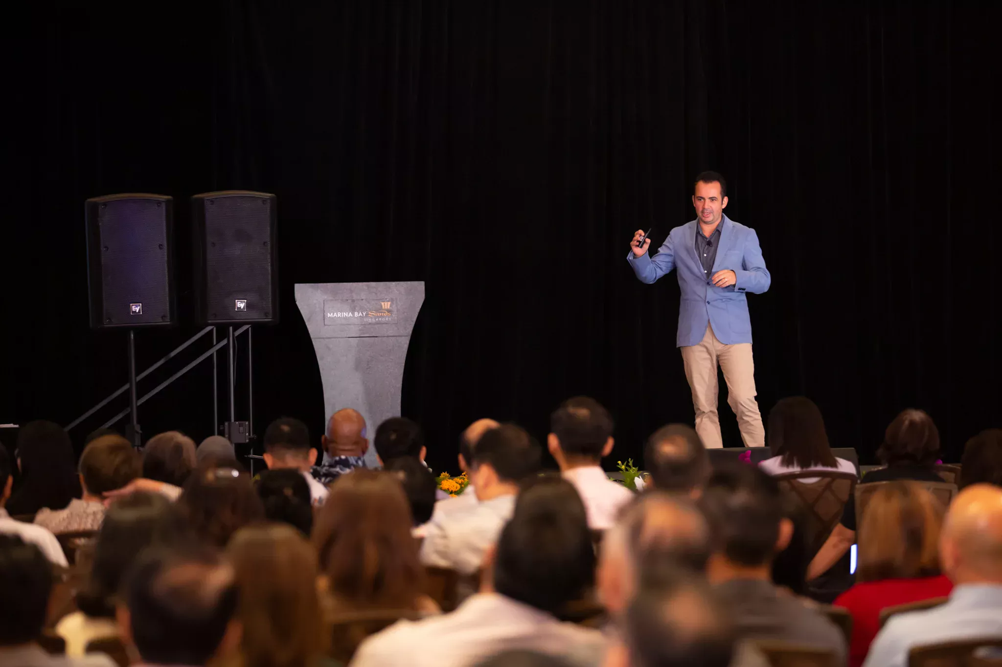 Marc Mekki speaking to an audience at Marina Bay Sands in Singapore